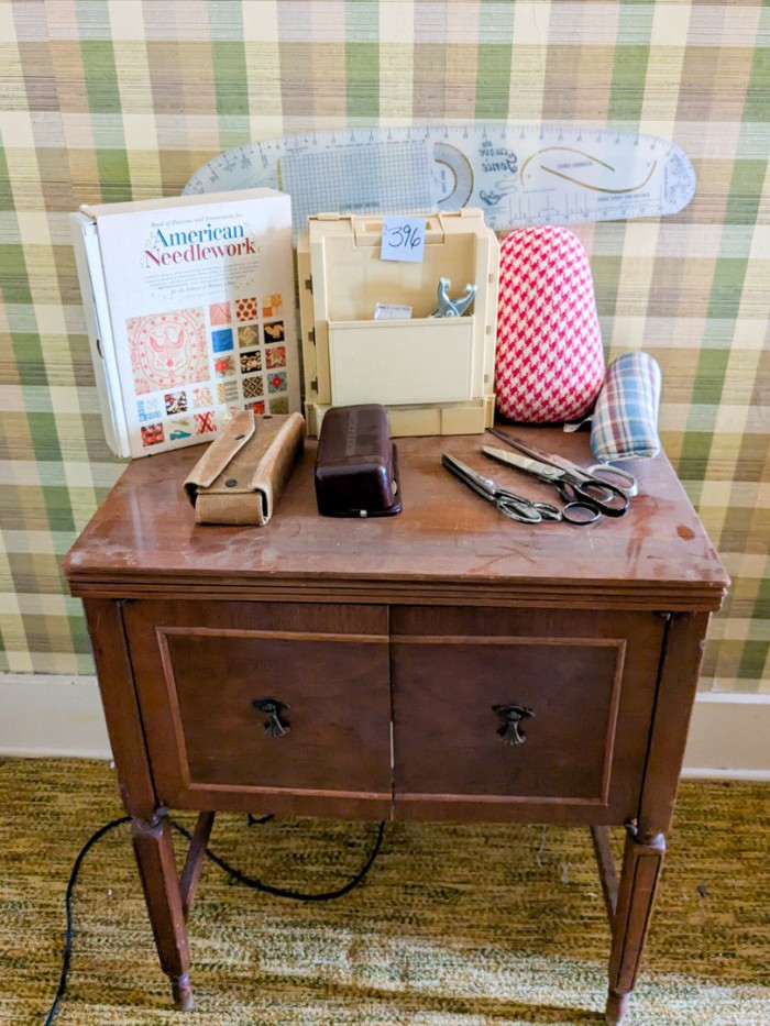 396. Sewing Machine in Table w/ Sewing Notions